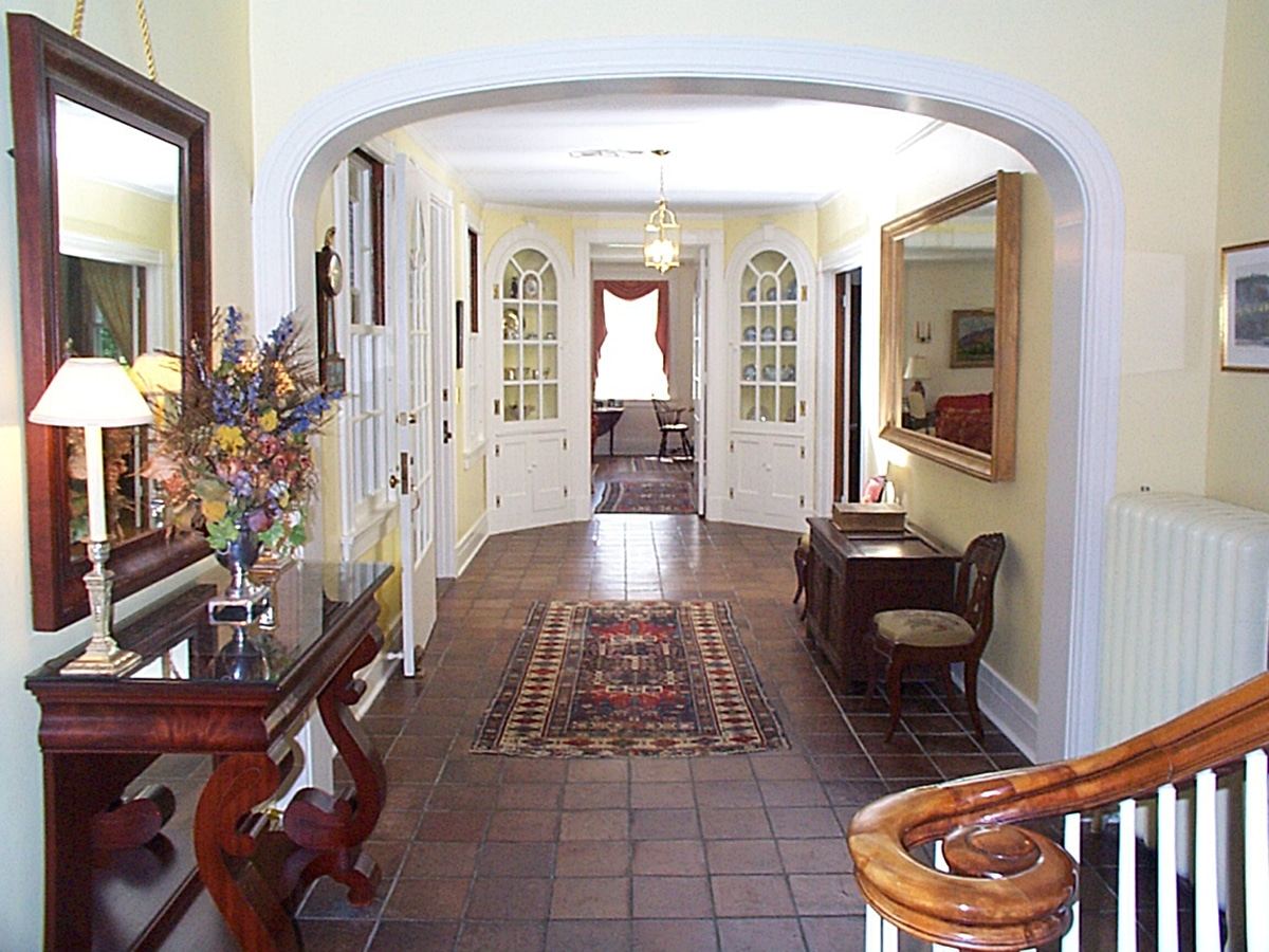 Foyer with arched doorway and china cabinets